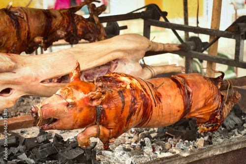 Traditional Balkan barbeque - roshtilj (roštilj) - young piglet and lamb roasted on the open fire 