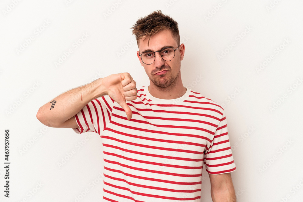 Young caucasian man isolated on white background showing thumb down, disappointment concept. Young caucasian man isolated on white background showing thumb down, disappointment concept.