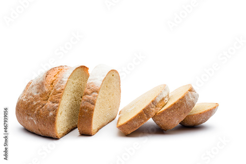 Fresh loaf of bread sliced on white background.