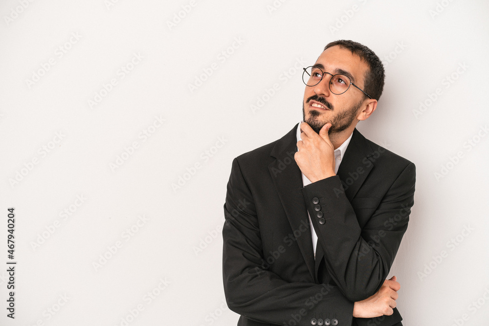 Young caucasian business man isolated on white background looking sideways with doubtful and skeptical expression. Young caucasian business man isolated on white background looking sideways with doubtful and skeptical expression.