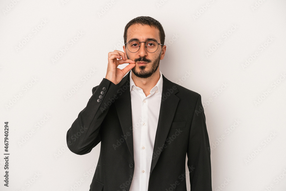 Young caucasian business man isolated on white background with fingers on lips keeping a secret. Young caucasian business man isolated on white background with fingers on lips keeping a secret.
