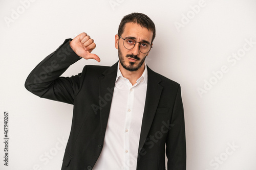 Young caucasian business man isolated on white background showing a dislike gesture, thumbs down. Disagreement concept.