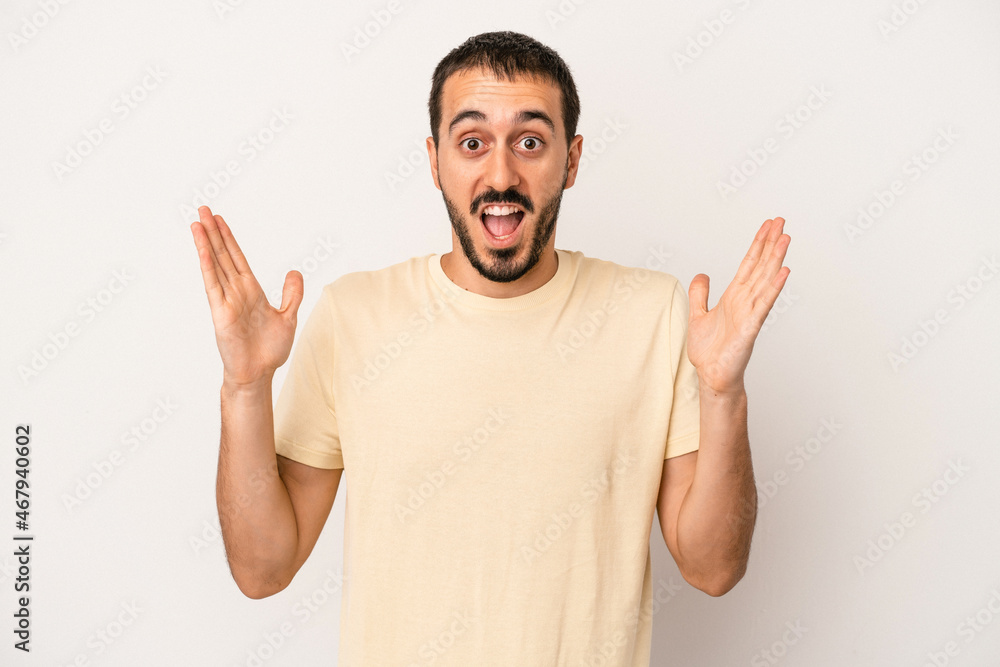 Young caucasian man isolated on white background celebrating a victory or success, he is surprised and shocked. Young caucasian man isolated on white background celebrating a victory or success, he is surprised and shocked.