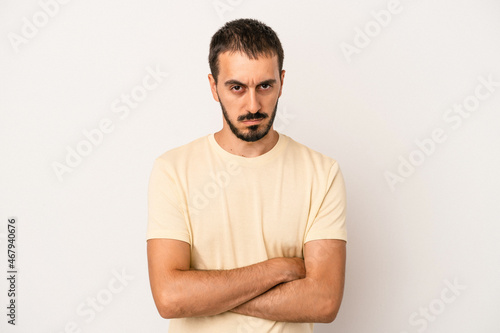 Young caucasian man isolated on white background unhappy looking in camera with sarcastic expression.