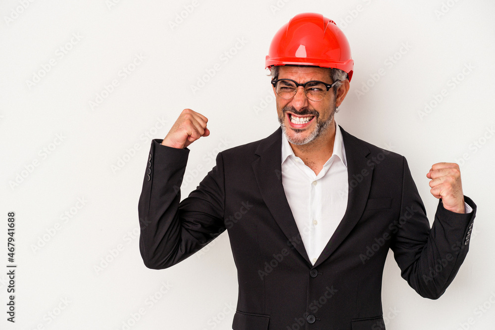 Middle age architect caucasian man isolated on white background  raising fist after a victory, winner concept.