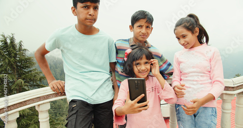 Photography Four little siblings from India taking a selfie outdoors on a sunny day