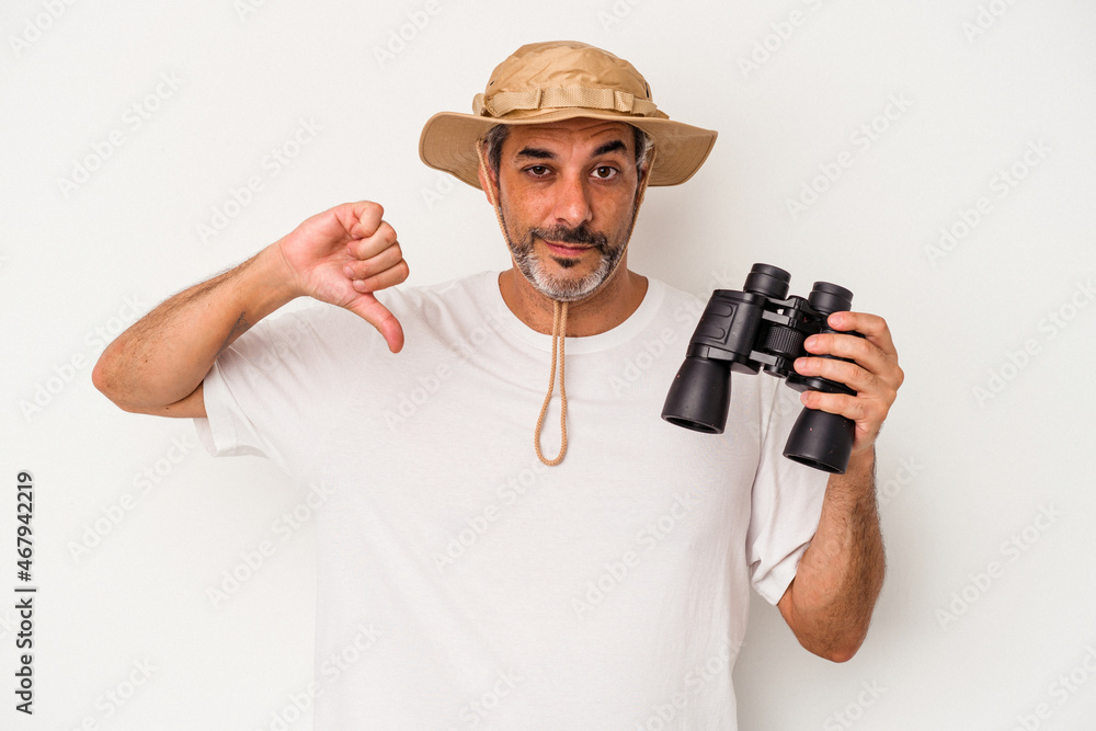 Middle age caucasian man holding binoculars isolated on white background showing a dislike gesture, thumbs down. Disagreement concept. Middle age caucasian man holding binoculars isolated on white background showing a dislike gesture, thumbs down. Disagreement concept.