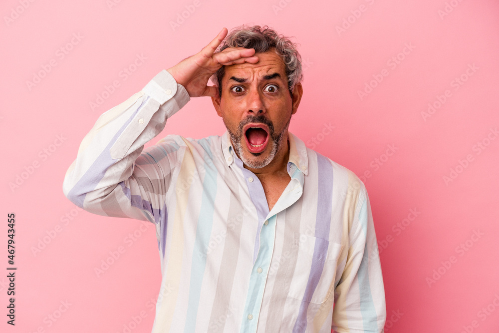 Middle age caucasian man isolated on pink background shouts loud, keeps eyes opened and hands tense. Middle age caucasian man isolated on pink background shouts loud, keeps eyes opened and hands tense.