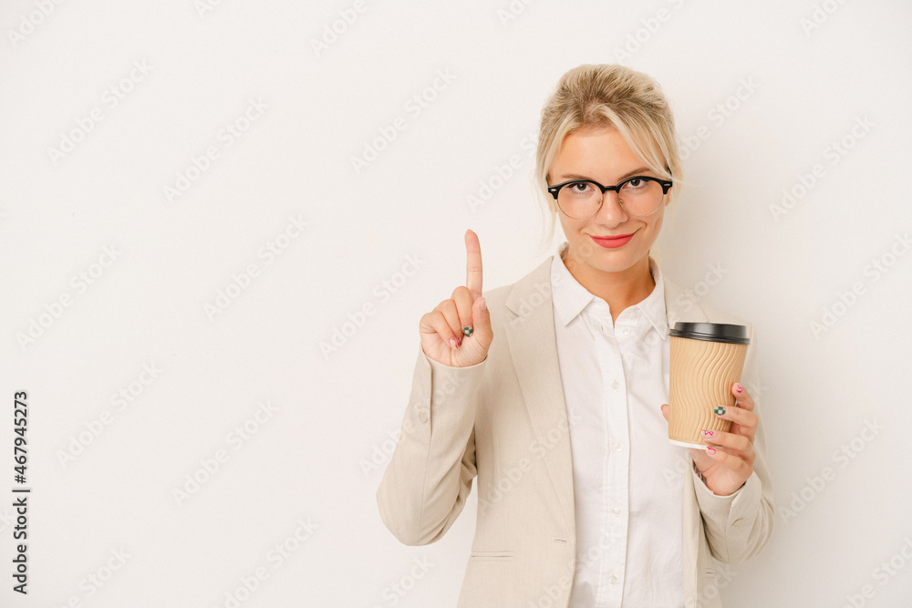 Young business Russian woman holding take away coffee isolated on white background showing number one with finger. Young business Russian woman holding take away coffee isolated on white background showing number one with finger.