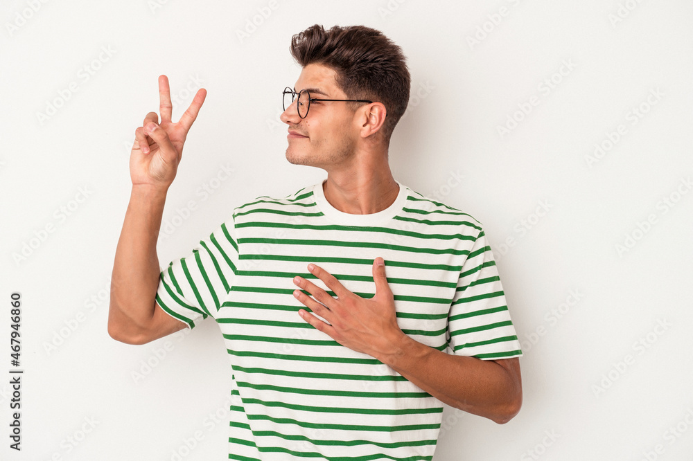 Young caucasian man isolated on white background taking an oath, putting hand on chest. Young caucasian man isolated on white background taking an oath, putting hand on chest.