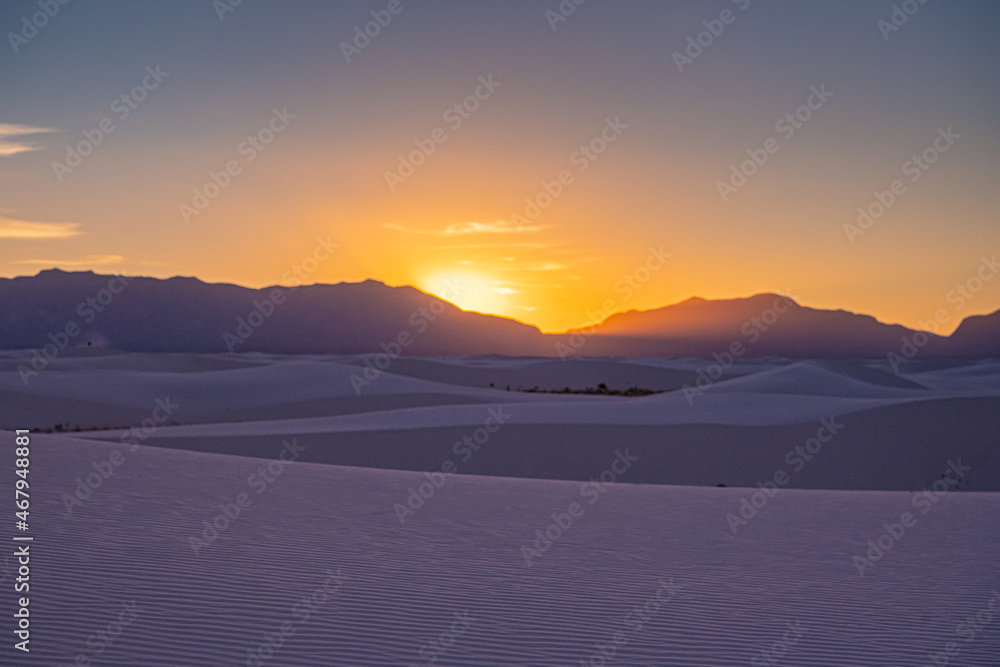 Sun Sets Behind San Andres Mountains Casting A Purple Tone Over White Sand Dunes