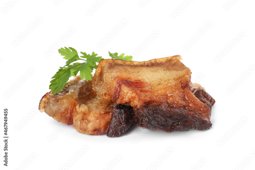 Tasty fried cracklings with parsley on white background. Cooked pork lard Tasty fried cracklings with parsley on white background. Cooked pork lard
