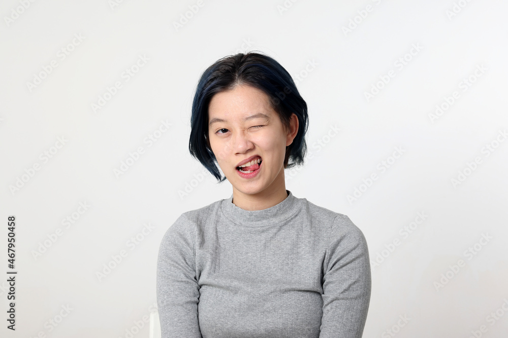 Young attractive Asian chinese malay woman pose face body expression mode emotion on white background wink Young attractive Asian chinese malay woman pose face body expression mode emotion on white background wink