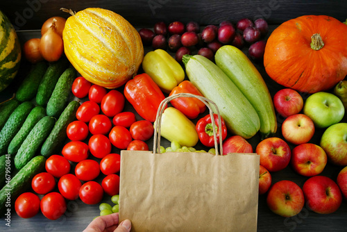 many different fruit and vegetables and paper bag, green glocery shop, healthy fresh colored fruits and vegetables background delivery concept. Zero waste photo