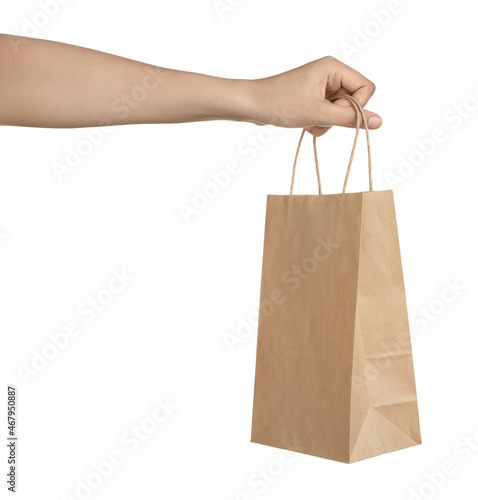 Woman holding shopping paper bag on white background