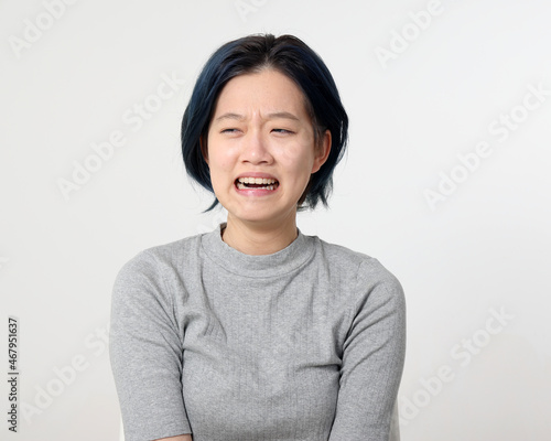 Young attractive Asian chinese malay woman pose face body expression mode emotion on white background cry