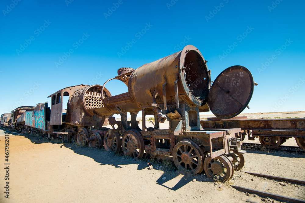 Rusty old steam train in Bolivian desert - train cemetery in Uyuni