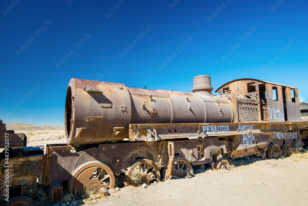 Rusty old steam train in Bolivian desert - train cemetery in Uyuni Rusty old steam train in Bolivian desert - train cemetery in Uyuni
