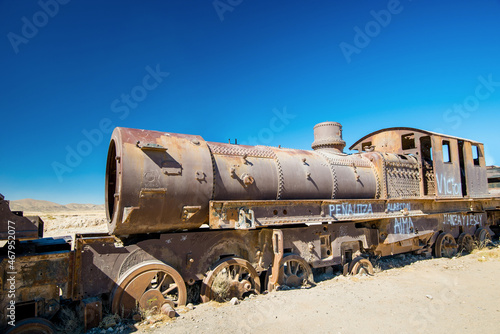 Rusty old steam train in Bolivian desert - train cemetery in Uyuni photo