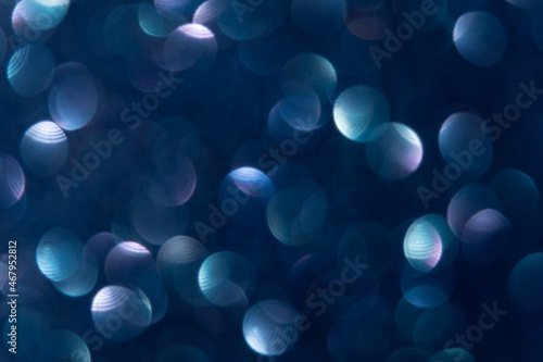 Bokeh light overlay. Circle pattern. Optical lens flare. Flash leak effect. Defocused blue purple round spot texture glow on blur dark night abstract background.