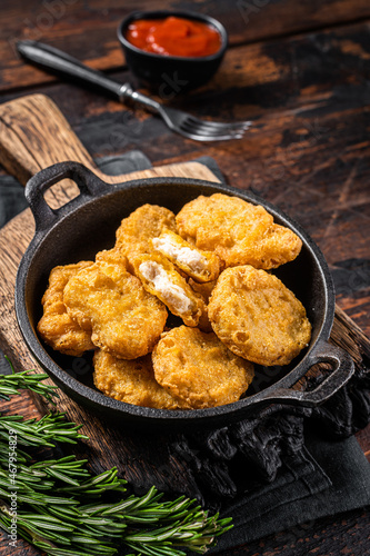 Fastfood - Chicken fried nuggets in a pan. Wooden background. Top view