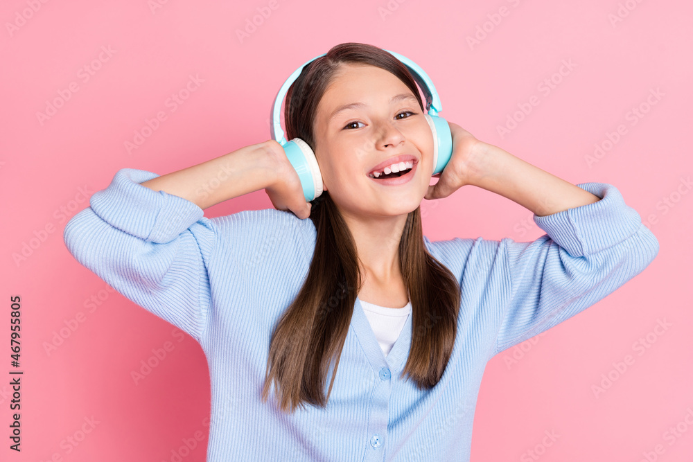 Photo of dreamy funny schoolgirl wear blue outfit listening music modern device smiling isolated pink color background Photo of dreamy funny schoolgirl wear blue outfit listening music modern device smiling isolated pink color background