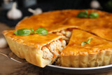 Delicious meat pie with basil on table, closeup