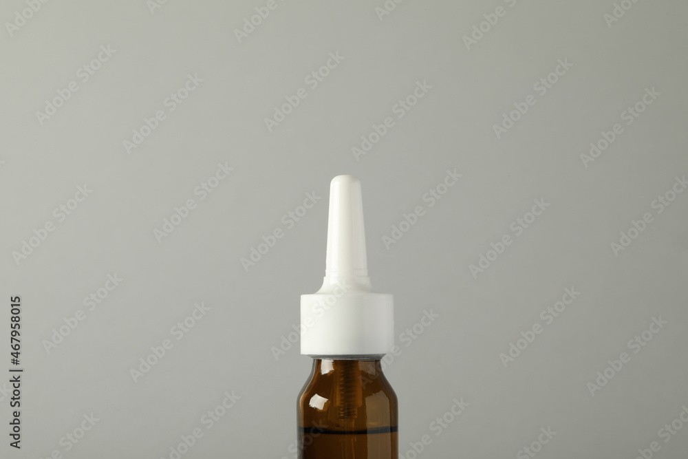Bottle of nasal spray on light grey background, closeup Bottle of nasal spray on light grey background, closeup