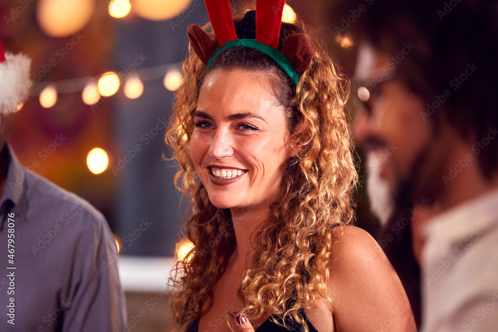 Fototapeta premium Multi-Cultural Group Of Friends Celebrating Dressing Up For Christmas Party In Bar