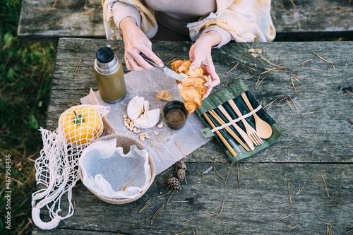 Vacation, healthy lifestyle, zero waste and sustainable plastic free concept. Cozy breakfast with cheese croissant, camembert at wooden tavle outdoor. photo