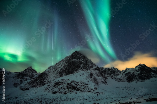 Aurora borealis, Northern lights with starry over snow mountain peak on winter