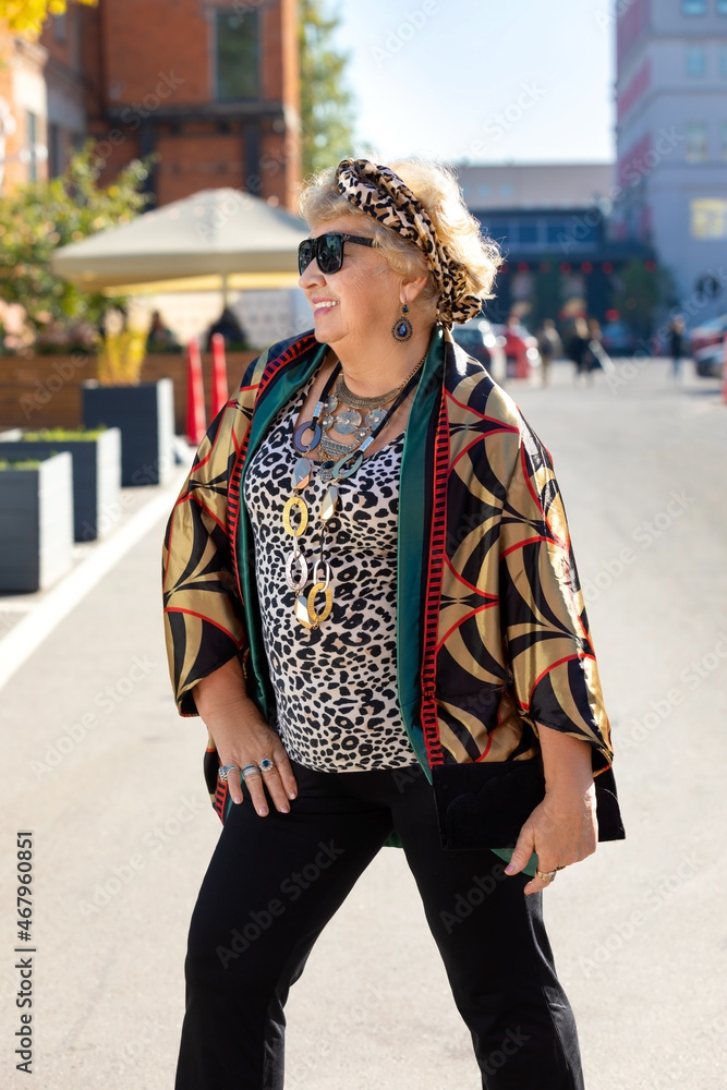 Stylishly dressed grandmother poses on the street