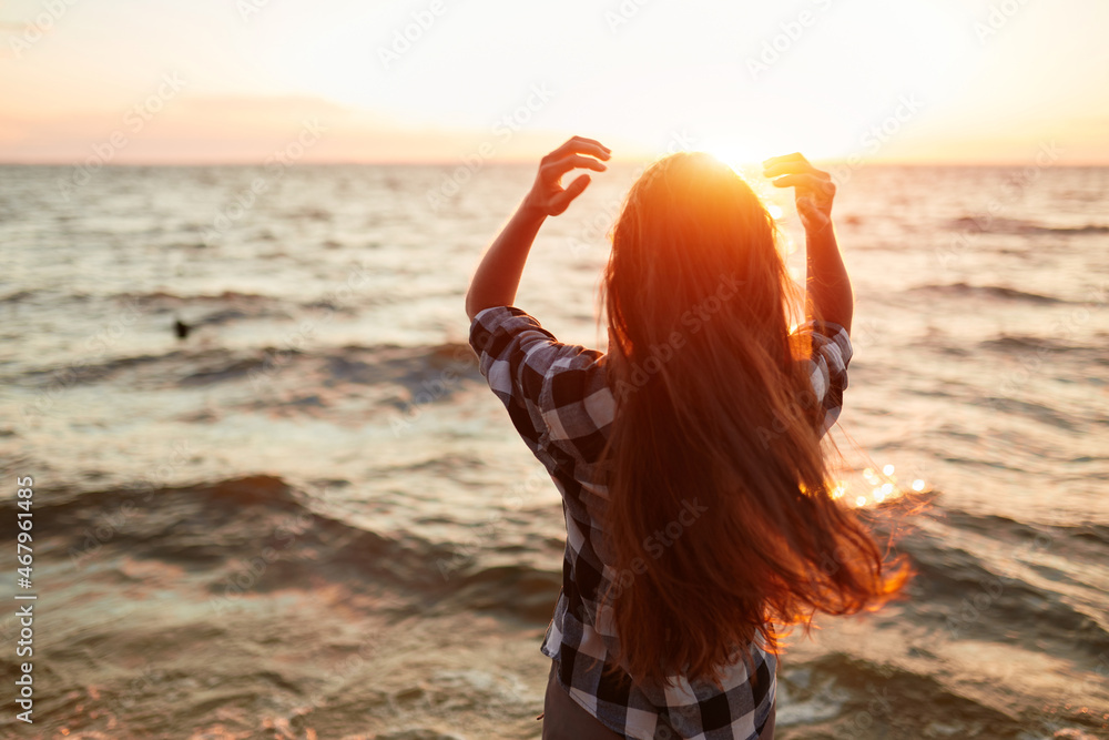 Portrait of young beautiful woman in sunset