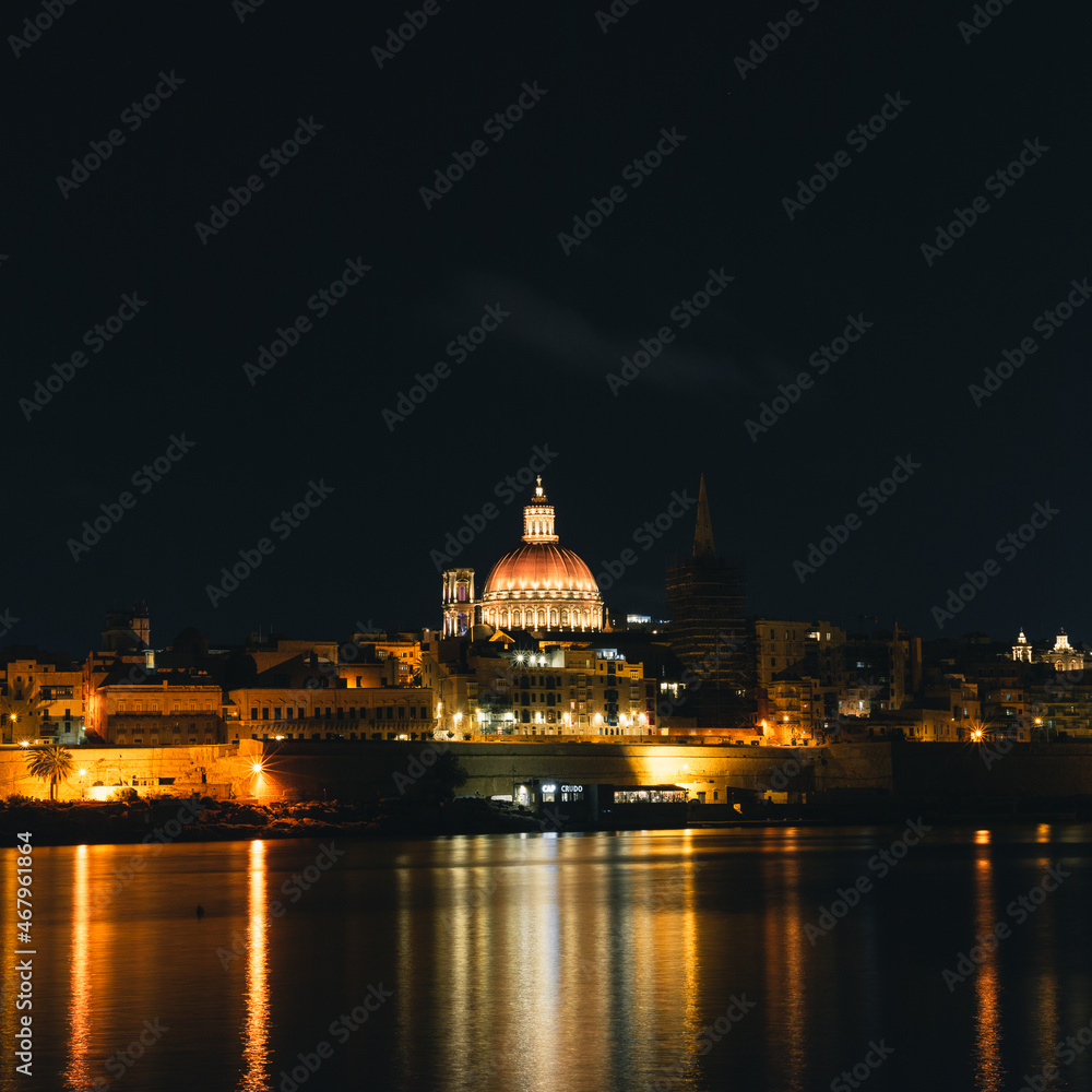 The view of Valletta's Basilica of Our Lady of Mount Carmel from Tigne Point at night