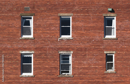 Old and run down brick building and windows facade
