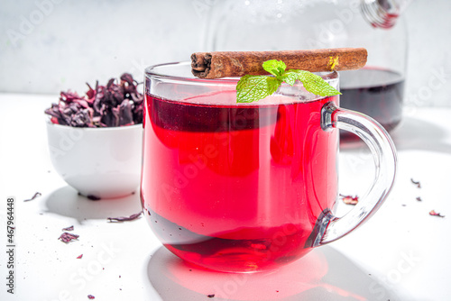 Red hibiscus tea, in glass cup. Healthy organic hot drink copy space