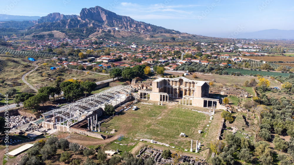 Fototapeta premium Aerial view with drone; Sardes (Sardis) Ancient City which has gymnasium and synagogue ruins and columns in Manisa, Turkey.