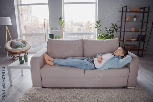 Dreamy inspired sleepy guy lay couch enjoy relax carefree chill day nap indoors