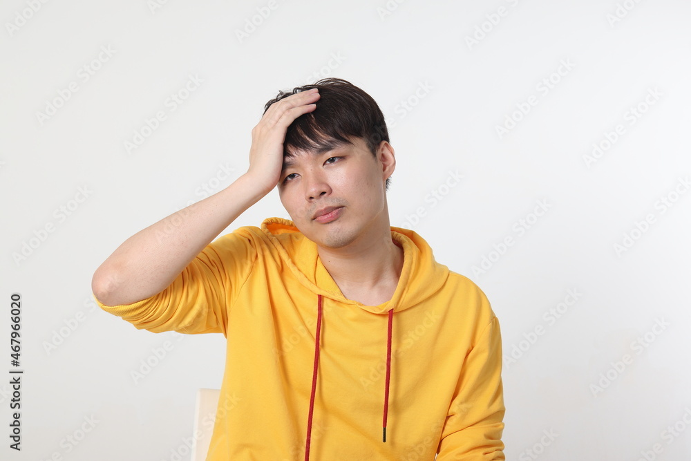 Young good looking Asian chinese malay man pose face body expression mode emotion on white background lost sad hand on head Young good looking Asian chinese malay man pose face body expression mode emotion on white background lost sad hand on head