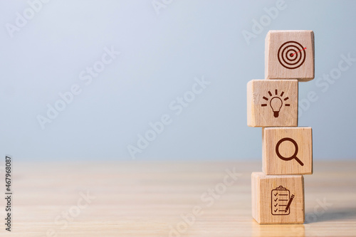 Wood cube block stacking with icon. business strategy and action plan Concept. photo
