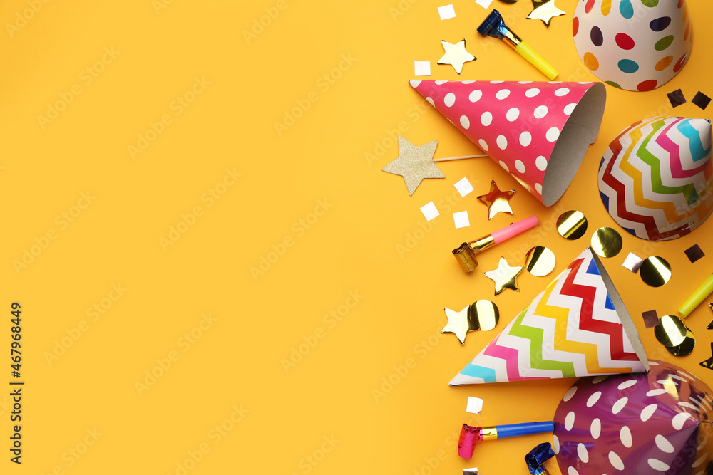 Flat lay composition with party hats and other festive items on orange background. Space for text Flat lay composition with party hats and other festive items on orange background. Space for text