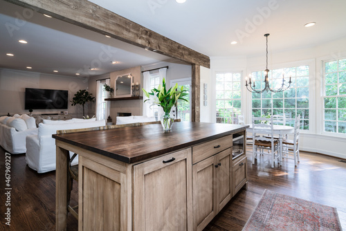 Kitchen island with butcher block counter and weathered beam in ceiling