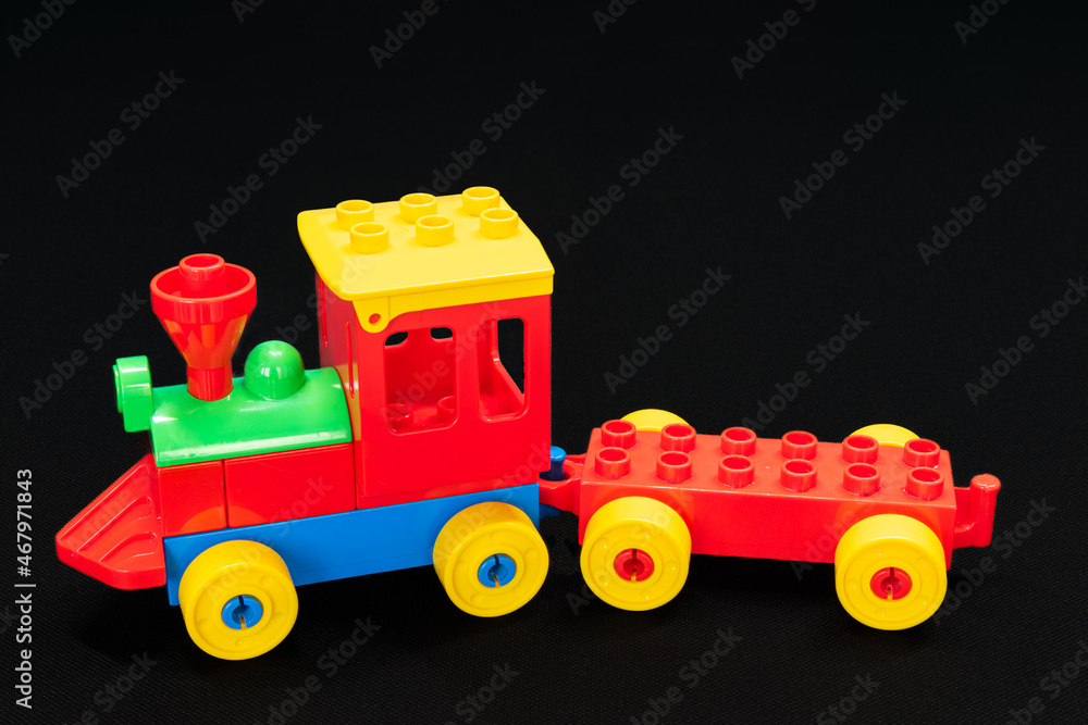 Children’s toy train made from large building blocks with the colours red, green, blue and yellow. Children’s toy train made from large building blocks with the colours red, green, blue and yellow.