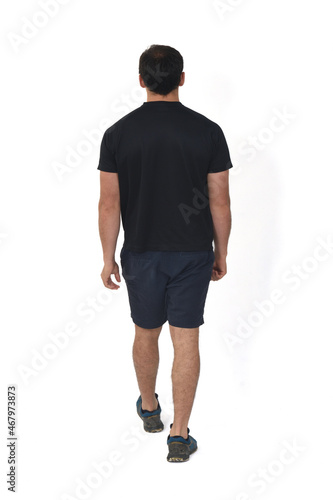 rear view of a man with sportwear walking on white background
