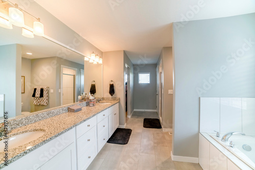 Master bathroom interior with rooms, light gray walls and marble flooring