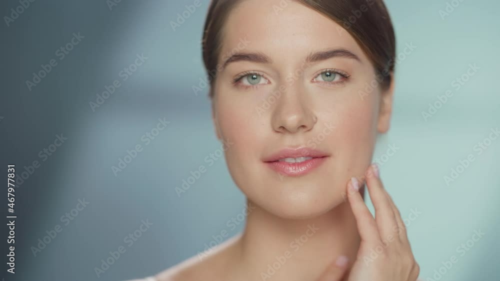 Female Beauty Portrait. Beautiful Caucasian Woman with Brown Hair and Light Green Eyes Posing, Touching Her Natural, Healthy Skin. Wellness and Skincare Concept on Soft Isolated Background. Close Up. Female Beauty Portrait. Beautiful Caucasian Woman with Brown Hair and Light Green Eyes Posing, Touching Her Natural, Healthy Skin. Wellness and Skincare Concept on Soft Isolated Background. Close Up.