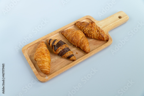 Delicious croissant on wooden plate. breakfast. french staple food.