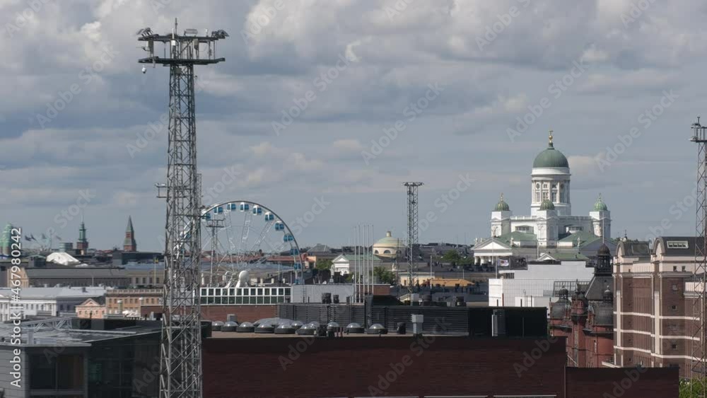 Helsinki.Finland-June 16.2021: Amazing shot of the Helsinki cityscape from the harbor. Cathedral. Ferris wheel. Ship. Beautiful nordic architecture. Camera zooming out and turning left. Helsinki.Finland-June 16.2021: Amazing shot of the Helsinki cityscape from the harbor. Cathedral. Ferris wheel. Ship. Beautiful nordic architecture. Camera zooming out and turning left.