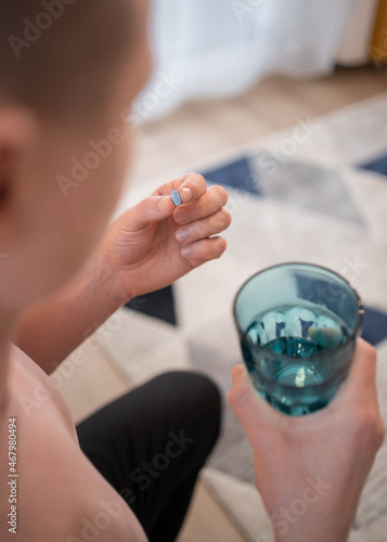 A young man takes a prep in a pill. HIV prevention concept. AIDS prevention concept.