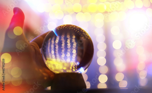 Fotografie, Obraz Crystal Ball on the floor with bokeh, lights behind